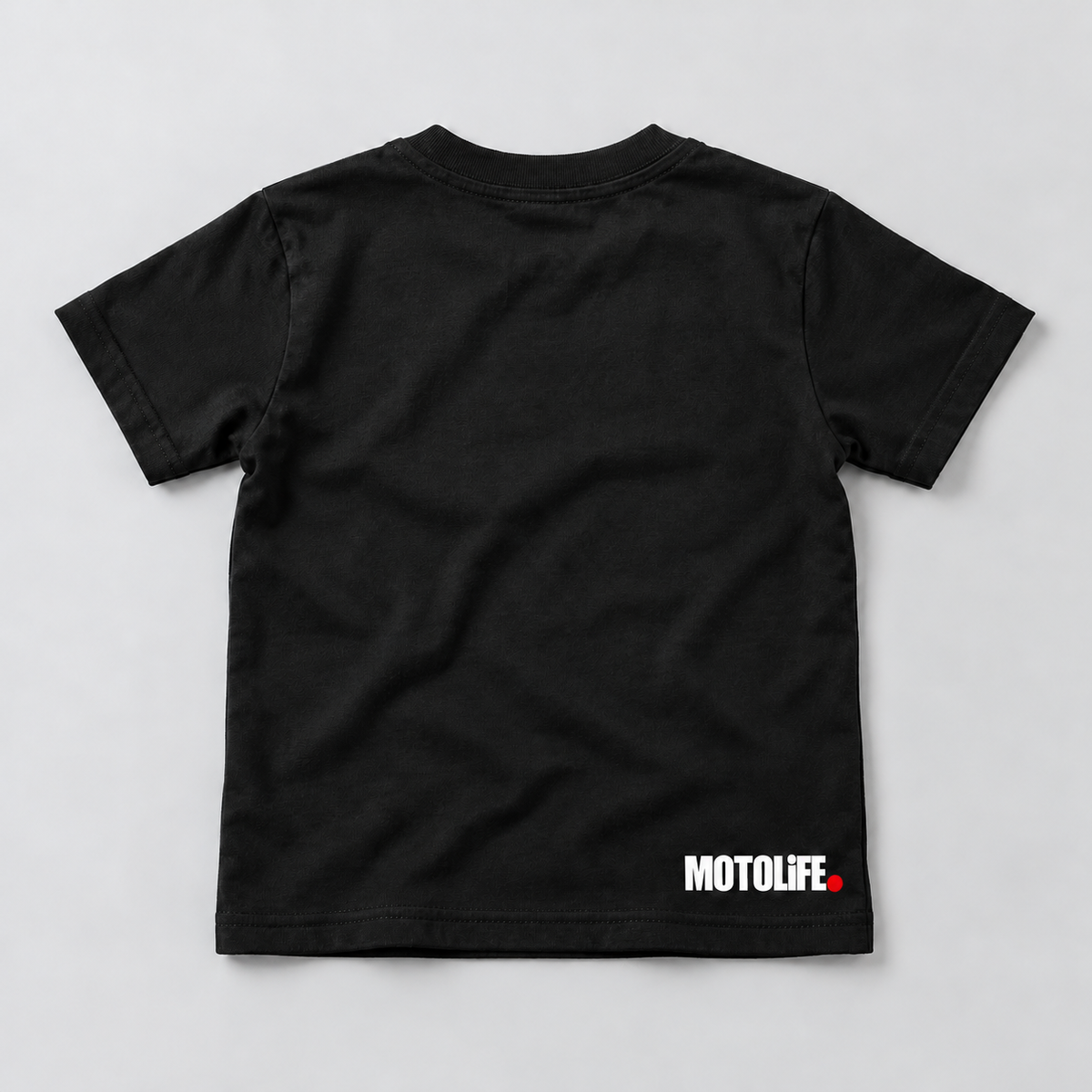 Black MOTOLiFE kids tee back flat-lay mockup with white lower-back wordmark and red period