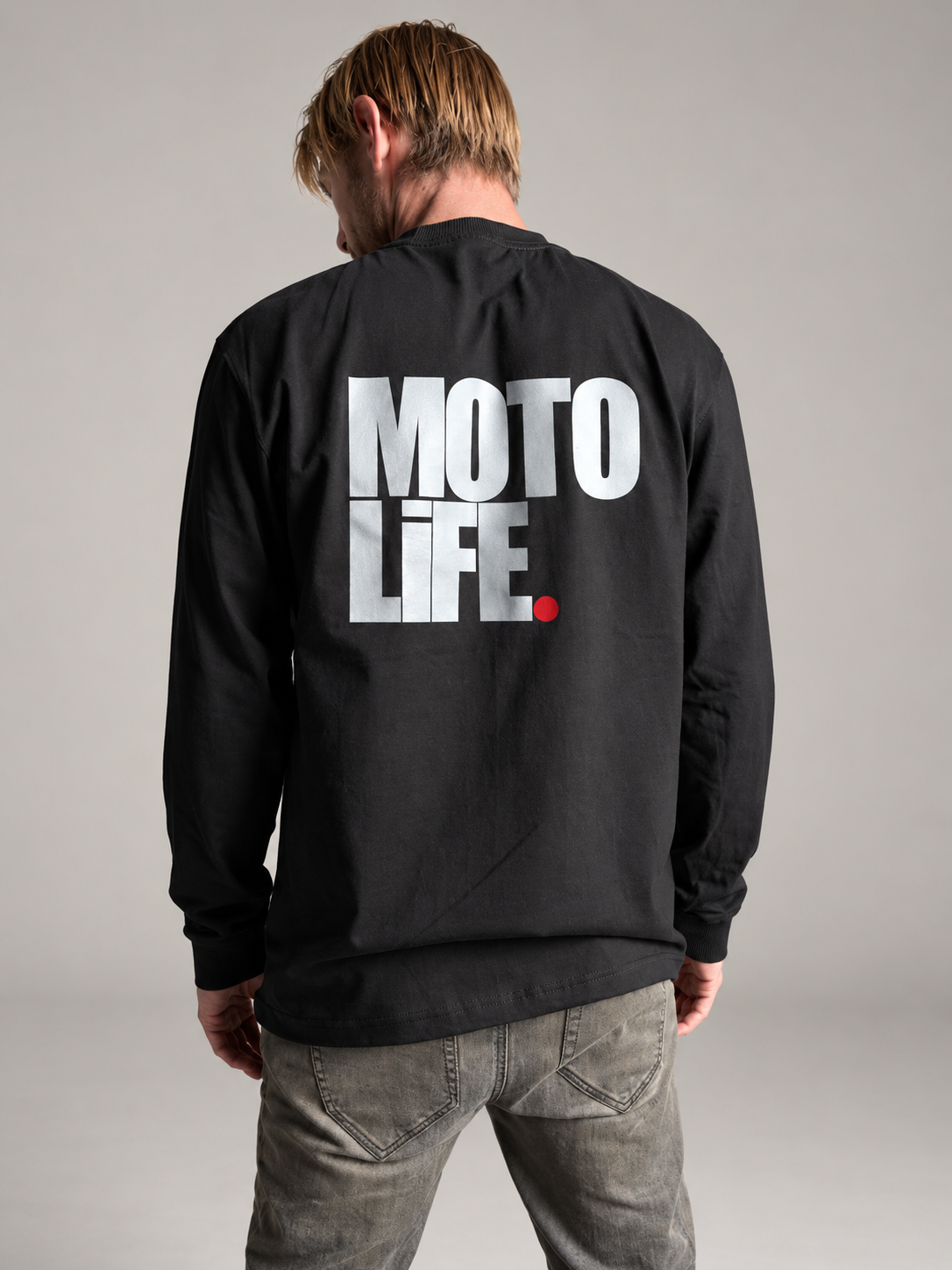 Black MOTOLiFE V2 long-sleeve T-shirt studio back view with large stacked silver reflective MOTO LIFE logo and red period.