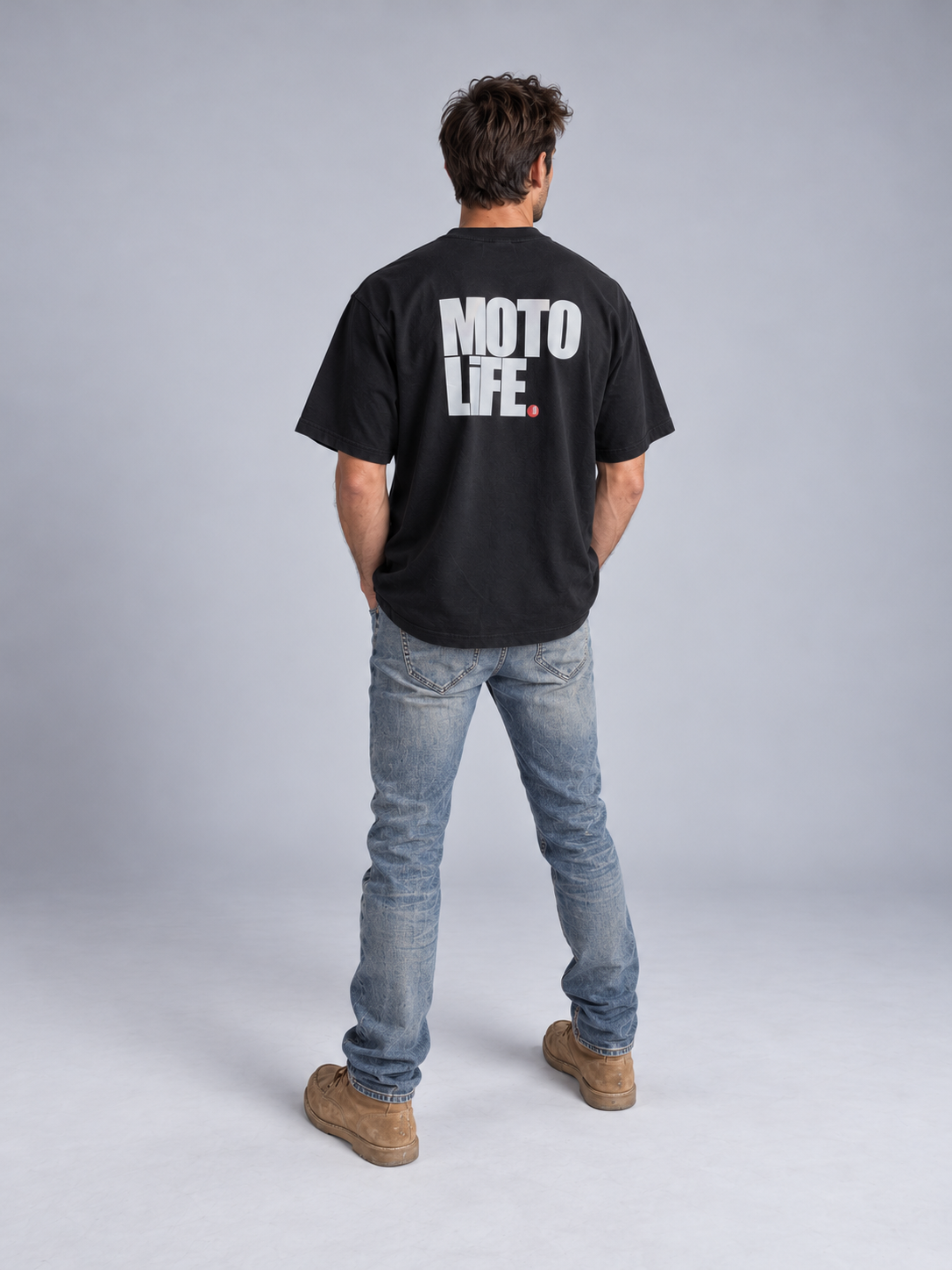 V2 black short-sleeve tee on model from behind with large stacked reflective MOTO LiFE back print and red period.