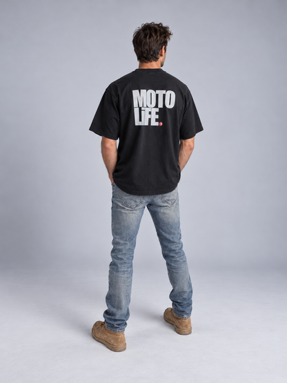 V2 black short-sleeve tee on model from behind with large stacked reflective MOTO LiFE back print and red period.
